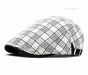 Detail of white plaid newsboy cap featuring adjustable metal side buckle and cotton fabric