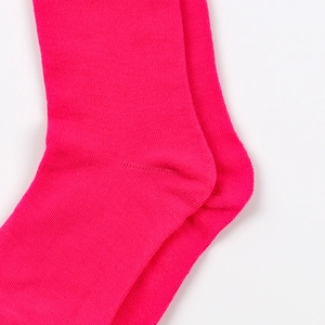 Close-up of bright pink calf socks showing the detailed knit texture and heel