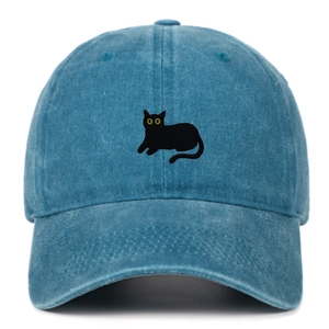 Detailed view of the black cat embroidery on a washed blue denim baseball cap