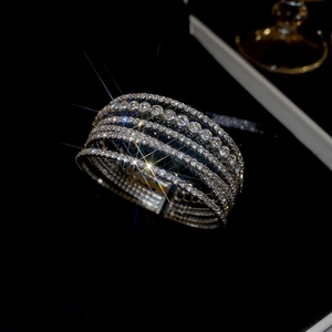 Close-up of a luxury silver-tone multilayer bangle with five rows of sparkling rhinestones