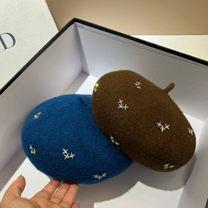 Close-up of wool berets with silver star rhinestones in blue and dark brown colors