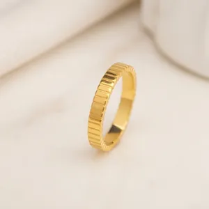 Vertical grooved 18k gold plated stainless steel ring with a minimalist polished finish