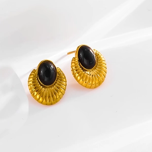 Vintage gold teardrop earrings with black stone inlay on a clean white background