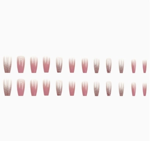 Detailed flat lay of 24pcs pink gradient ballet nails with sparkling glitter accents