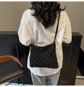 Detail of black macramé woven crossbody bag with stylish bohemian fringe and shoulder strap