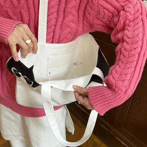 Detail of white canvas tote bag inner zipper pocket and thick fabric texture