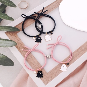 Ghost matching heart magnetic bracelets for couples in black and pink braided cords