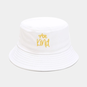Close-up of yellow 'be Kind' heart embroidery on a premium white cotton bucket hat
