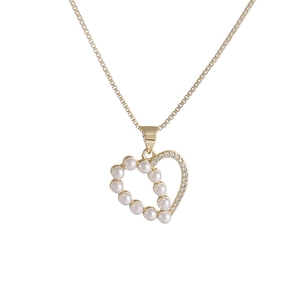 Golden heart pendant necklace with elegant white pearls and zircon stones on white background