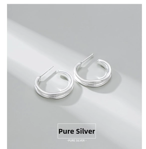 Macro shot of S925 sterling silver C-shaped earrings with brushed and polished texture