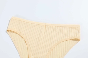 Detail of light yellow ribbed cotton panties showing fine knit texture and stitching