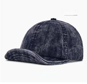 Close-up of navy blue corduroy baseball cap with soft brim and ribbed fabric texture