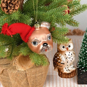 Festive Christmas tree ornaments featuring a glittery bulldog and painted glass owl hanging