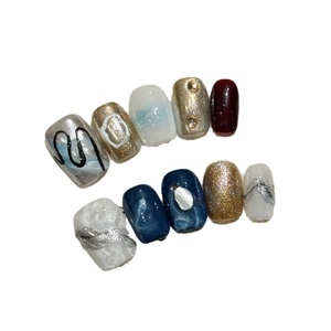 Handmade blue and wine red marble cat-eye press-on nails with 3D gold embossed details