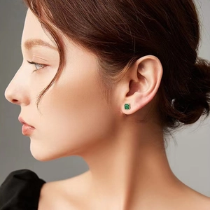 S925 silver square emerald stud earrings worn by a model against a minimalist background