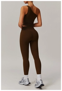 Rear view of high waist yoga pants and one shoulder crop top in dark brown