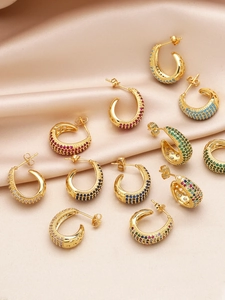 Detailed close-up of 18k gold plated hoop earrings with multicolored cubic zirconia stones