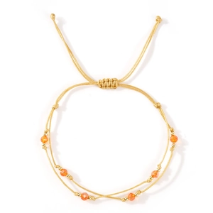 Double-layer woven gold rope bracelet featuring orange crystal beads and adjustable slide knot