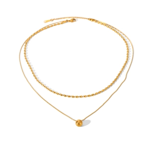Detail of a double-layer gold beaded necklace featuring a circular pendant on white base