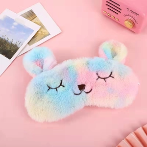 Detailed close-up of rainbow plush sleep mask with cute bear ears and embroidery