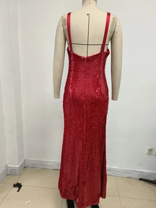 Detailed view of red sequin evening gown with open back design on display mannequin