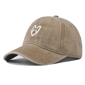 Detail of the heart embroidery and premium washed twill fabric on khaki baseball cap
