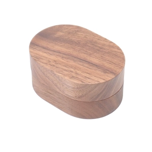 Close-up of oval black walnut wood jewelry box with natural grain and smooth finish