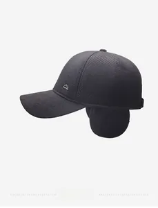 Detail view of winter baseball cap with earflaps and side mountain logo emblem