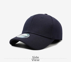 Detail view of navy blue baseball cap showing brim sticker and cotton fabric texture