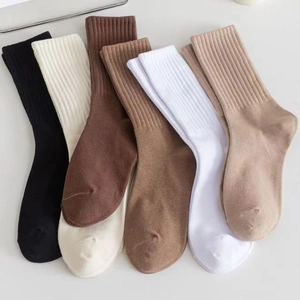 Neutral ribbed cotton crew socks in black, white, brown, and beige colors on white background