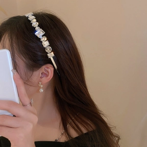 Detailed view of luxury wide headband with sparkling round and square crystals