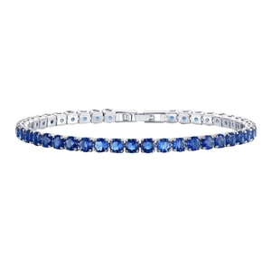 Detail of classic silver tennis bracelet featuring prong-set round blue sapphire zircons