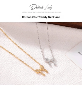 Close-up of gold and silver hollow bow necklaces featuring sparkling zircon stones