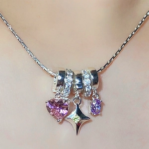 Star and heart pendant necklace with pink, purple, and green gems on a silver chain