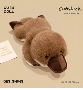 Close-up of deep brown plush platypus doll showing soft texture and glittery golden eyes