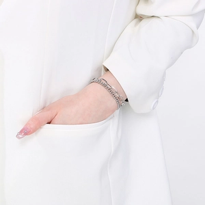 Detail of layered silver stainless steel bracelet with paperclip and cuban chain design