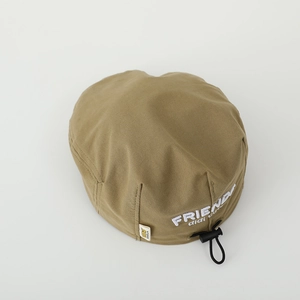 Detail of khaki children beret featuring white FRIEND letter embroidery and adjustable cord