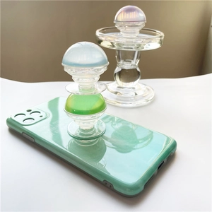Detail of mint green glossy phone case with iridescent crystal ball phone grip