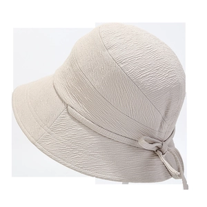 Detail of beige bucket hat showing seersucker fabric texture and elegant side bow detail