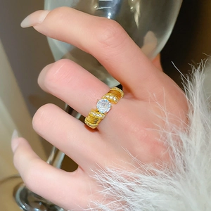 Close-up of elegant gold flower ring with large round zircon and sparkling pave crystals