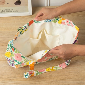 Detail of floral canvas tote bag featuring white fabric lining and double inner pockets