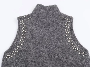 Detail of grey wool blend knit top featuring intricate rhinestone and bead embellishments