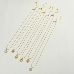 Detailed view of six gold celestial necklaces with diamond-encrusted star and moon charms