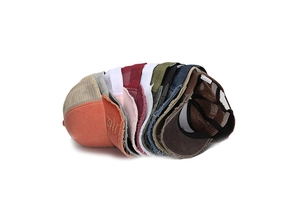 Detail of distressed mesh trucker hats in multiple colors with frayed edge design