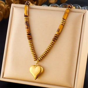 Tiger eye stone necklace with gold heart pendant displayed in a premium jewelry box