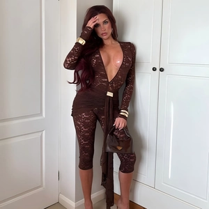 Detail of dark brown lace bodysuit featuring deep V-neck and decorative golden waist buckle