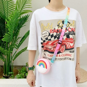 Girl wearing a pink silicone donut bag with rainbow pattern and gradient strap