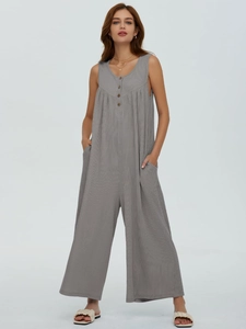 Detail of grey sleeveless knit jumpsuit showing wooden buttons and textured fabric