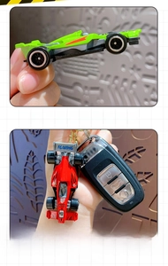Close-up of red and green alloy racing car keychains with detailed painted finish