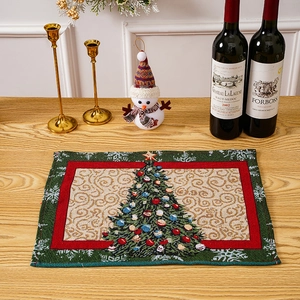 Detailed view of jacquard Christmas placemat with festive tree pattern on wooden table